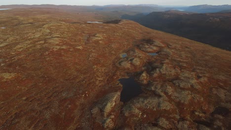 Areal-footage-of-mountain-plateau-and-a-valley-in-a-far-in-Southern-Norway