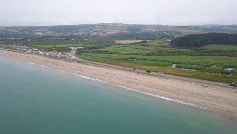 Cornwall-coastal-road-along-British-beach,-aerial-dolly-view