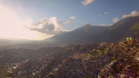 Drone-view-of-Petare-slum,-in-Caracas,-Venezuela,-during-a-sunset
