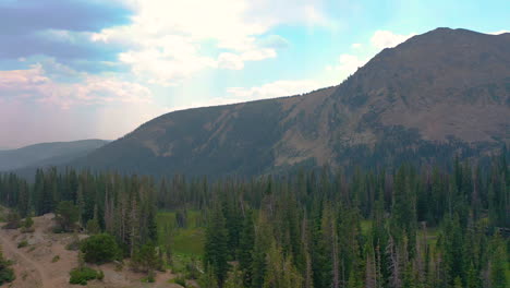 Aerial-Drone-Reveal-of-Nederland-Colorado-Mountain-Peak-Views-and-Lush-Pine-Tree-Forest-during-Summer-in-the-Rocky-Mountains