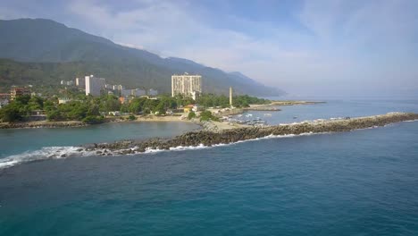 Drone-shot-view-of-the-breakwater-coastline-in-the-calm-Caribbean-Sea