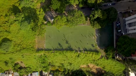 Aerial-view-of-a-soccer-game-and-field-during-a-golden-hour,-in-Caracas,-Venezuela