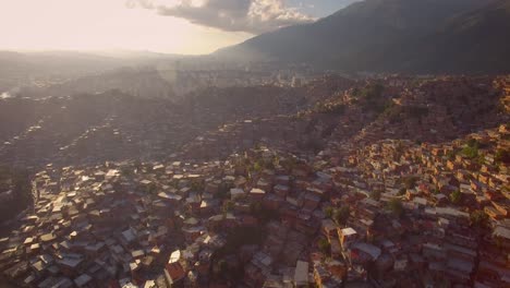 Aerial-of-Petare-slum,-in-Caracas,-Venezuela,-during-a-sunset