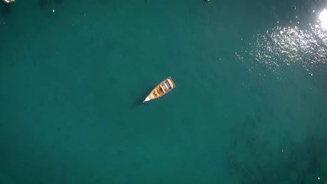 Bird-eye-view-of-a-small-fishing-boat-floating-in-a-calm-Caribbean-Sea-Marina