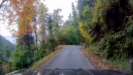 SUV-driving-through-narrow,-dangerous-and-curved-mountainous-roads
