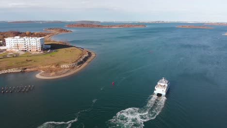 Aerial-drone-footage-following-the-a-commuter-boat-in-the-harbor-during-the-day-and-then-overtaking-it