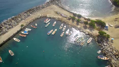Birds-eye-view-of-a-group-of-small-fishing-boats-tied-in-a-small-marina