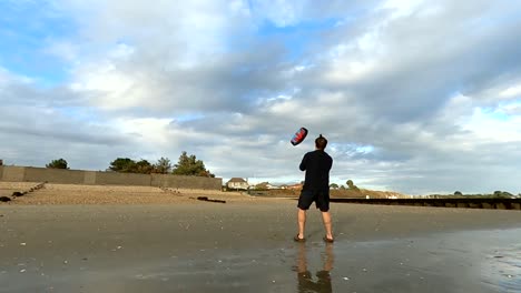 Man-flying-a-power-kite-on-the-beach