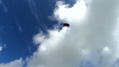 Power-kite-flying-high-in-the-sky-with-a-blue-summer-sky-in-the-back-ground