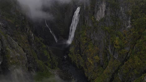 Cinematic-drone-footage-of-flying-away-from-Vøringsfossen-waterfall-in-Western-Norway