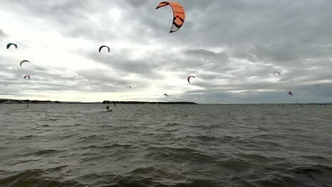 A-british-harbour-full-of-kitesurfers-riding-across-the-scene