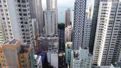 Mega-residential-buildings-and-traffic-in-downtown-Hong-Kong,-Aerial-view