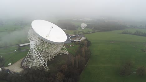 Aerial-Jodrell-bank-observatory-Lovell-telescope-misty-rural-countryside-front-view-orbit-left