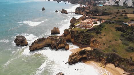 Rocky-coastline,-Praia-dos-Estudantes-beach,-Lagos,-Algarve