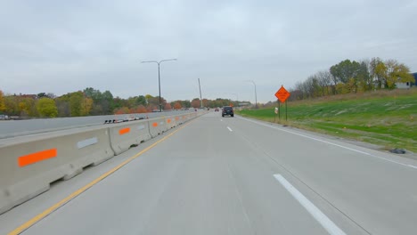 POV-while-driving-thru-a-construction-site-on-Interstate-I74-near-the-Mississippi-River-in-late-Fall-on-a-cloudy-day-in-Moline-Illinois