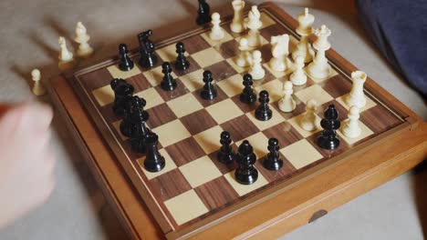 Hand-Moving-the-Checkers-on-a-Chessboard-during-a-Home-Game---Slow-Motion