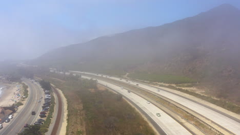 Car-cruising-up-and-down-Freeway-101-under-a-layer-of-thin-mist-seeping-in-from-the-ocean