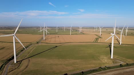 Wind-Turbines-Spinning-Propellor-Blades-in-Countryside-Field,-Aerial