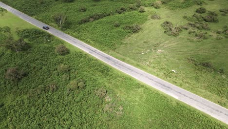 Cars-driving-on-countryside-road-in-Hartland,-North-Devon,-Aerial-Orbiting-Pan