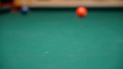 Slow-Motion-Billiards-Cue-Ball-Hits-Green-6-ball-with-Spin-and-Full-Contact-Close-Up-on-Pool-Table-with-Green-Felt-from-a-Low-Angle