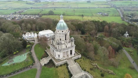 Aerial-view-landmark-historical-copper-dome-building-Ashton-Memorial-English-countryside-push-in-rising-tilt-down