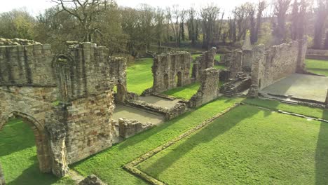 Basingwerk-abbey-landmark-medieval-abandoned-Welsh-ruins-Aerial-view-slow-left-to-close