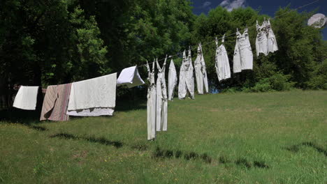 Clothing-And-Beddings-On-Clothesline-Drying-Under-The-Sunlight-In-The-Backyard---static-shot