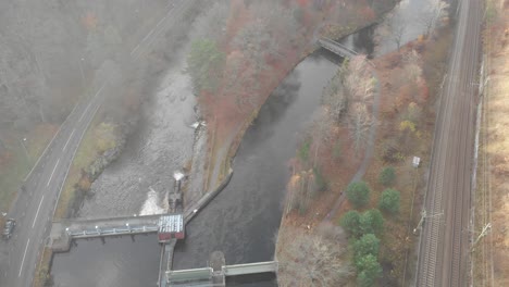 Aerial-Shot-of-Small-Hydroelectric-Dam-in-River,-High-Angle-Frame-Fill