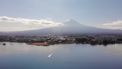 High-above-sideways-drone-flight-over-Lake-and-Mount-Fuji-on-bright-and-sunny-day