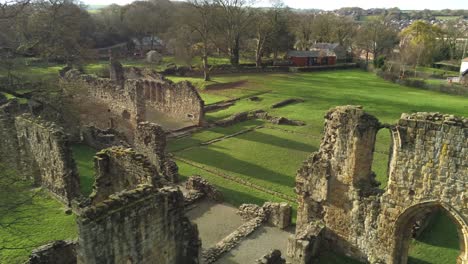 Basingwerk-abbey-landmark-medieval-abandoned-Welsh-ruins-Aerial-view-dolly-close-right