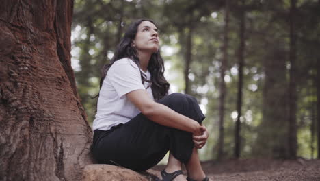 Spiritual-spanish-woman-sitting-in-peace-at-Sequoia-California-forest