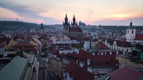 Day-to-night-sunset-timelapse-of-the-Prašná-Brána-,-Old-Town-Hall,-Prague-Castle-and-the-rest-of-downtown-Prague,-Czech-Republic-as-it-lights-up-during-the-night