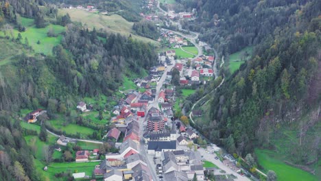 Fly-over-picturesque-town-along-valley-Alps,Eisenkappel-Vellach,-Austria