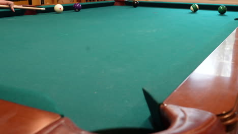 Man-Wins-Game-of-8-Ball-Pool-by-Shooting-Two-Solid-Balls-into-Pockets-then-Sinking-the-Black-Eight-Ball-Using-a-Draw-Stroke-or-Backspin-to-Spin-the-Cue-Ball-Across-the-Table-for-Victory,-No-Faces