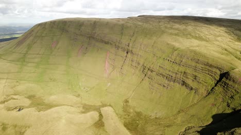 Vast-majestic-Llyn-y-fan-Fach-Brecon-beacons-green-mountain-wilderness-countryside-aerial-dolly-right-view
