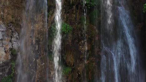 Tight-aerial-shot-pulling-away-from-a-tiered-waterfall-in-Sopotnica,-Serbia