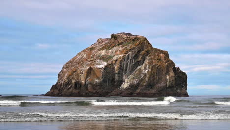 Rock-Formation-Reflected-Through-Clear-Water-Of-Oregon-Coast,-Face-Rock-In-Bandon