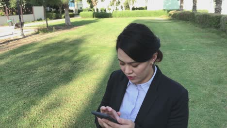 Woman-using-mobile-phone-with-5G-network-wearing-business-corporate-attire