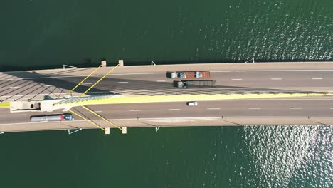 Aerial-top-down-view-of-the-traffic-bridge-above-the-ocean