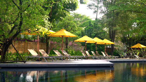 umbrella-and-pool-bed-decoration-around-swimming-pool-in-hotel-resort