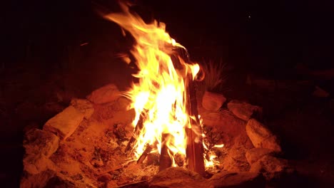 Handheld-shot-of-a-campfire-with-teepee-build