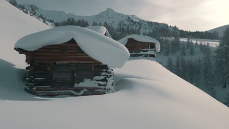 Drone-nature-footage-of-freshly-snowed-mountain-huts-in-South-Tyrol