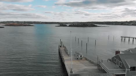 Drone-perspective-of-a-Hingham-Yacht-Club-flyover-toward-Hingham-Harbor-and-the-town-of-Hingham,-MA-USA---aerial-view-over-water