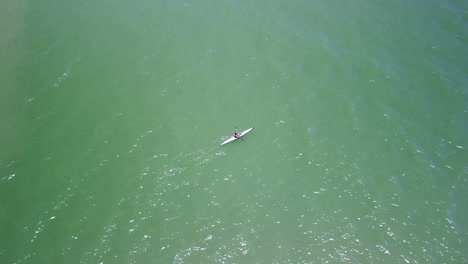 Lone-Person-Kayaking-Across-Open-Waters-Off-Trinity-Beach-In-Cairns
