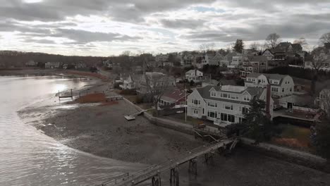 Drone-Flying-On-A-Cloudy-Day-By-The-Hingham-Harbor-Towards-Crow-Point,-Luxurious-Village-With-Expensive-Houses-In-Massachusetts---aerial