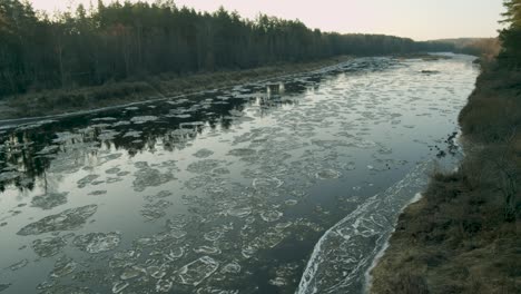 Ice-chunks-going-slow-river-down-stream-in-sunny-winter-day