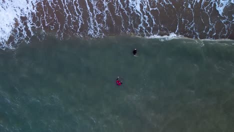 Aerial-Top-Down-View-Of-Two-People-Wading-In-Waters-At-Trinity-Beach