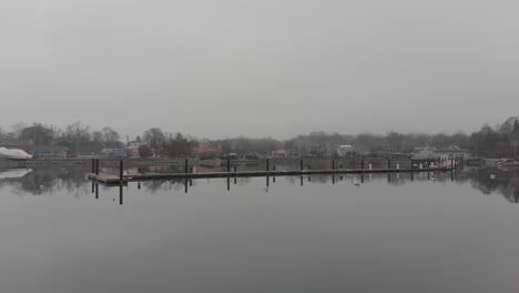 A-calm-movement-of-drone-on-shore-dock-in-a-cold-foggy-day