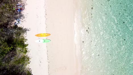 Aerial-View-Of-Two-Paddle-Boards-On-Green-Island-Beach