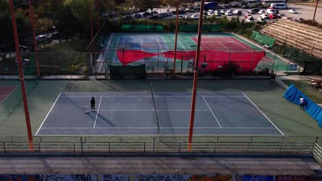 4K-drone-clip-of-a-tennis-court-over-a-sports-complex-in-Thessaloniki,-Greece